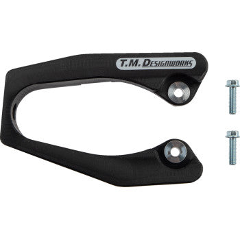 A Honda Front Chain Slider Black by T.M. Designworks, made from advanced composite material, with two silver bolts next to it on a white background.