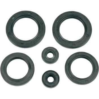 Five black rubber oil seals from the Polaris Oil Seal Kit by K&S Technologies, each round with a hollow center and OEM replacement design in varying sizes, are arranged in a loose circle on a white background.