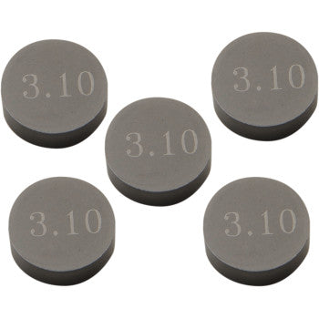 Five Prox Valve Shims (9.48 mm x 3.10 mm, pack of 5) are arranged in a loose pattern against a white background, each precision machined and engraved with “3.10.”.