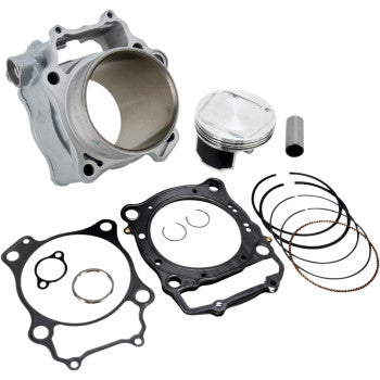 Silver metal cylinder with smooth inner bore, matching piston with rings, two black gaskets, and small metal pin and clips.