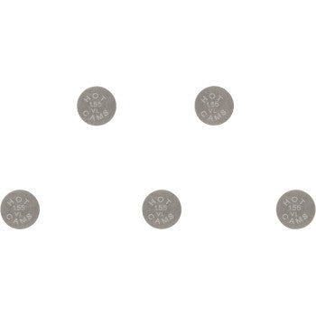 Five small, round, metallic valve shims engraved with size markings and brand details.