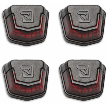 Set of four black and red polygonal Polaris Xpedition trunk bed lights with Ravek logo embossed on top surface.