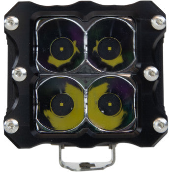 Close-up of the LED Quattro Light Spot by Heretic—a square, black aircraft-grade aluminum light with four CREE LEDs in a 2x2 grid, each emitting a yellowish tint and secured by screws at each corner.