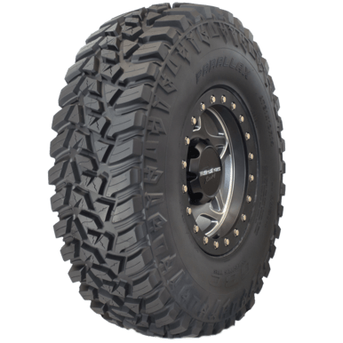 The Tire Parallax 35X10.00R15 by GBC is a large, rugged off-road tire with deep, aggressive tread patterns, sidewall lugs, and a black metal rim for superior traction on rough terrains.