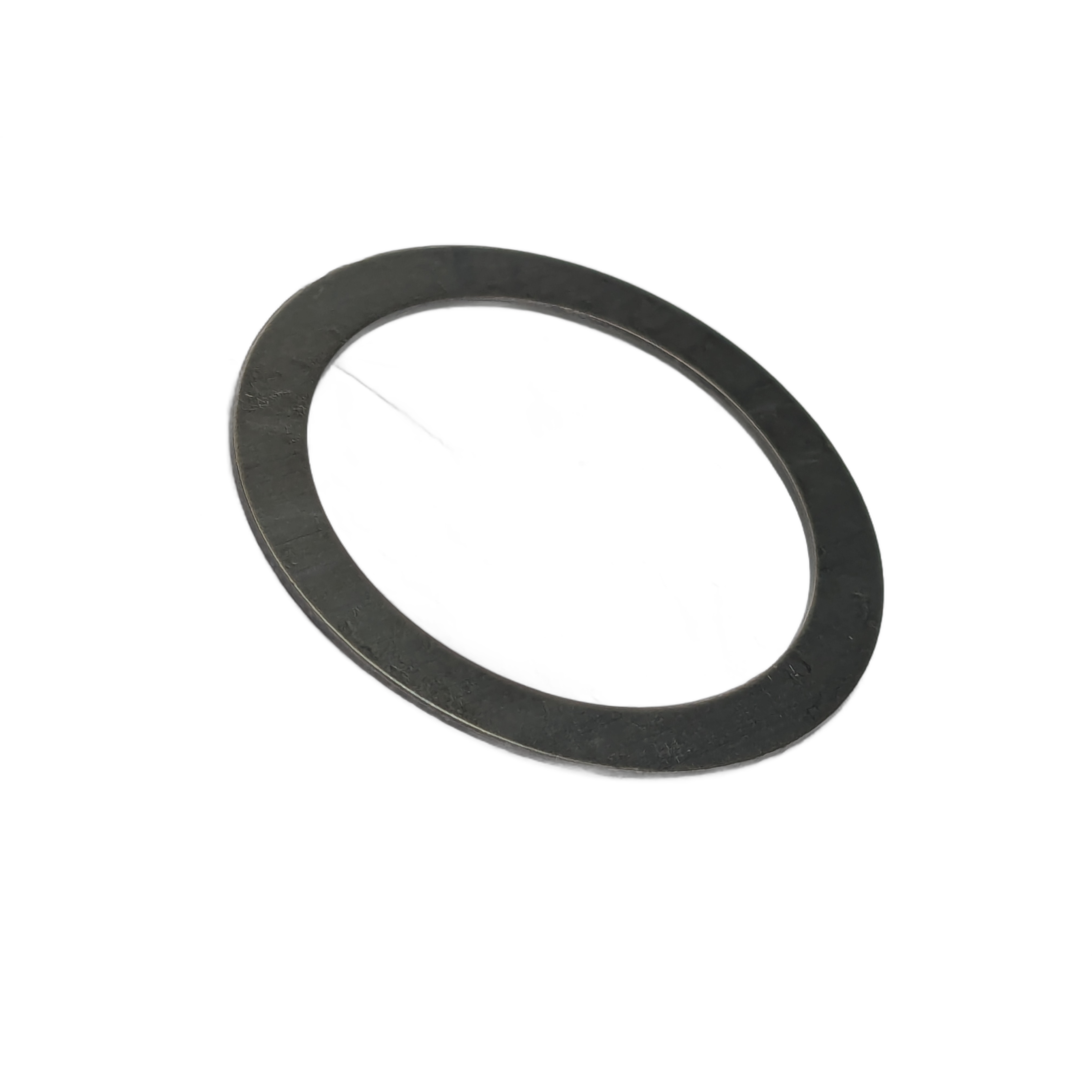 Thin dark metal shim washer with smooth flat surface and circular shape.