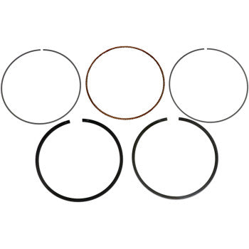 The Honda Ring Set by Prox includes five circular piston rings in two rows—three on top, two below—with one brown ring and others in black and gray, each varying in thickness as OEM replacements.