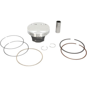 Silver metallic piston with black base, accompanied by multiple metal piston rings and a small cylindrical pin on a white.