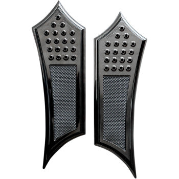 A pair of extended, black, shield-shaped Front Floorboards by Accutronix, crafted from billet aluminum with drilled circular studs on top and textured slip-resistant grips on the lower half.