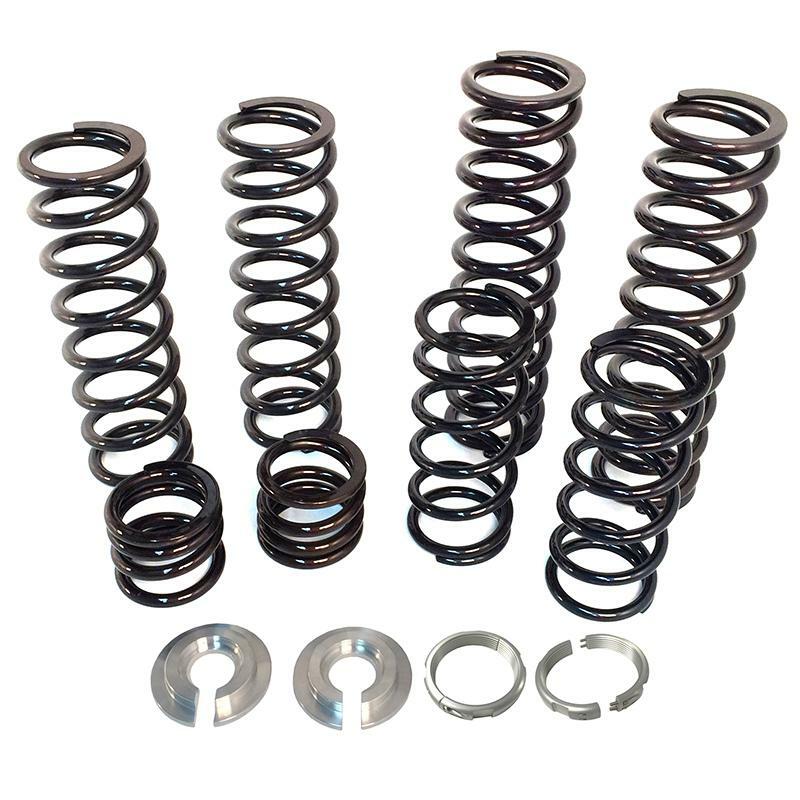 The Polaris Dual Rate Spring Kit by ZBroz features six assorted metal coil springs and four round mounting components, designed to boost ride height and ensure a smoother ride, displayed on a white background.