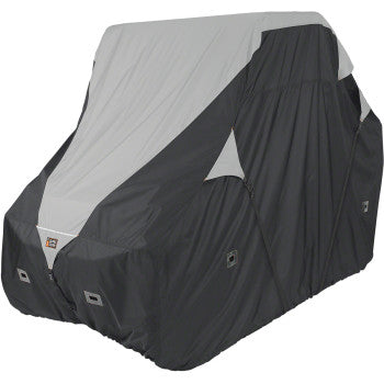 A large vehicle is fully concealed by the UTV Deluxe Cover Black / Gray Large by Classic Accessories, crafted from water-resistant fabric to protect against the elements and keep details hidden.