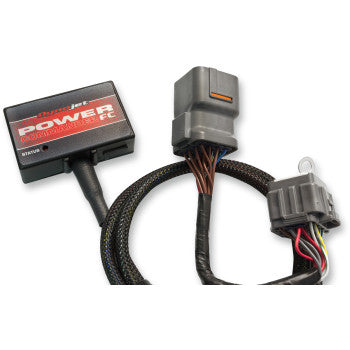 Black rectangular Yamaha Power Commander fuel controller with braided wiring harness and gray connectors.