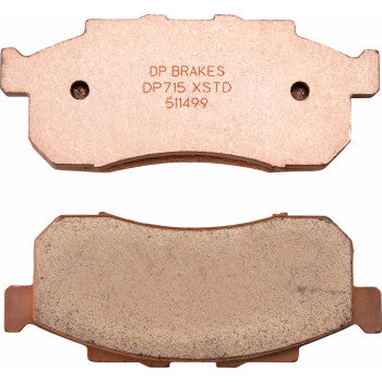 Two Sintered Brake Pads by DP Brakes are shown—one features engraved text "DP BRAKES DP715 XSTD 511499," while the other displays its friction surface for fade-free performance.