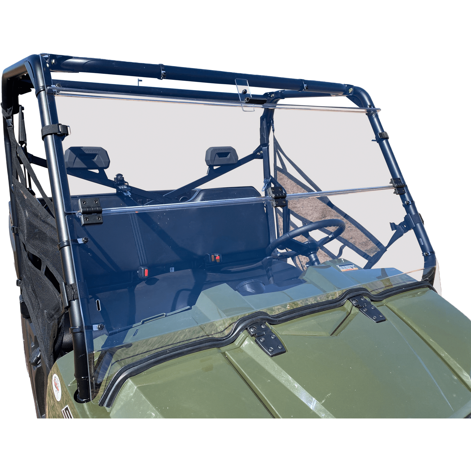 A green off-road vehicle equipped with the Folding Windshield by Open Trail for water protection. Black frame, two front seats with headrests, steering wheel and dashboard visible from the front drivers side.