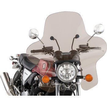 A motorcycle with a large Slipstreamer Enterprise Windshield - Smoke attached to the handlebars, featuring round mirrors, orange turn signals, and a front headlight. The bikes red and silver body is accented by stylish chrome details.