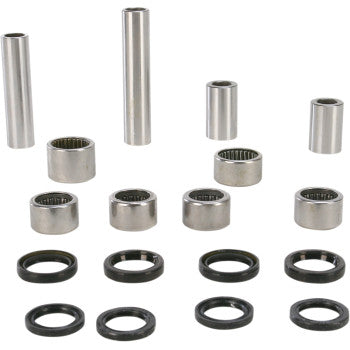 The Linkage Rebuild Kit by Pivot Works includes metal bearings, lower shock bearings, bushings, and black seals of various sizes, neatly arranged and engineered to meet OEM specs for suspension control systems.