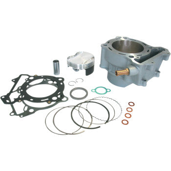 Gray metal cylinder block with piston, piston rings, gaskets, seals, and small copper washers laid out on white background.