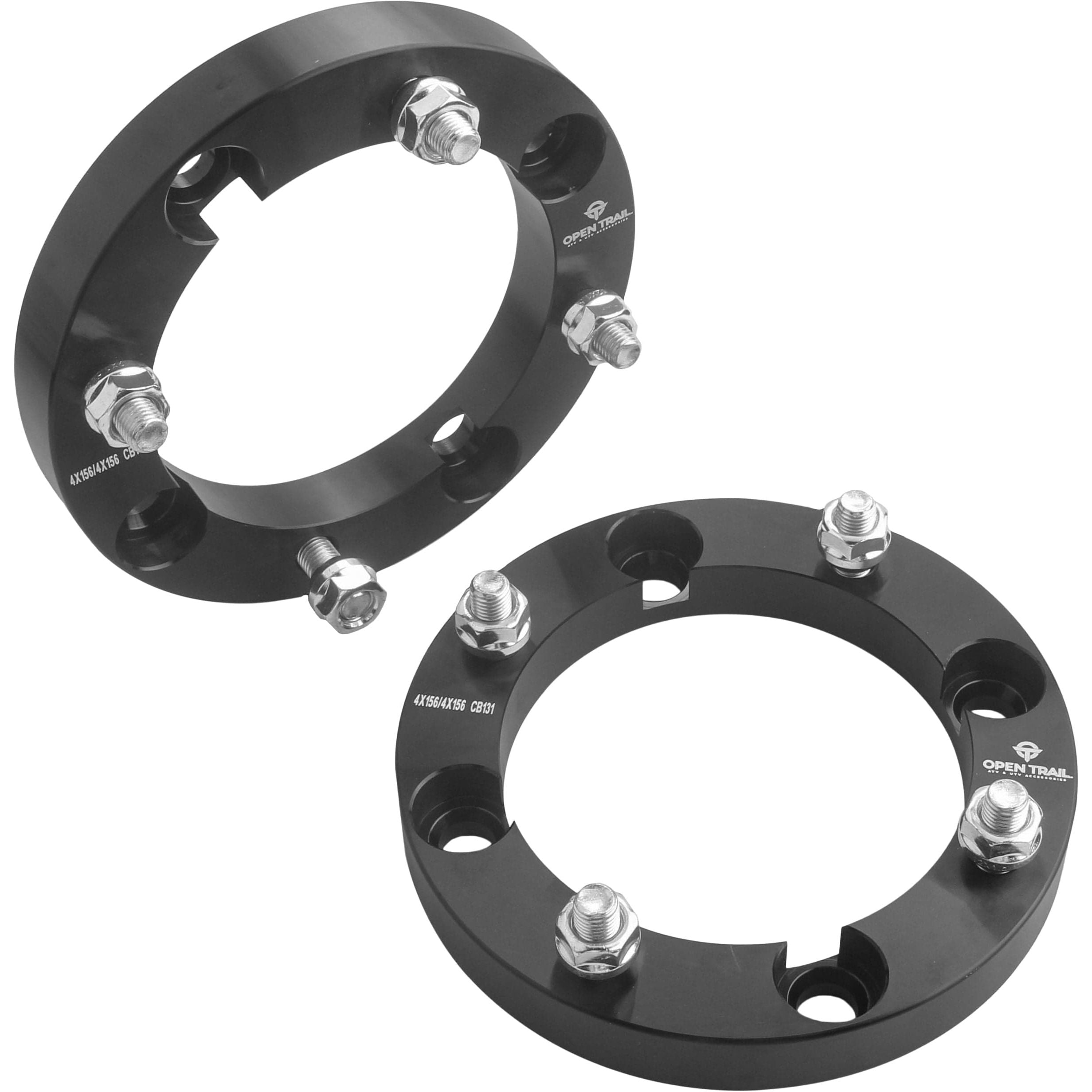 Two black Open Trail Wheel Spacer 1 4/156 Stud: 12mm x 1.25mm units with bolts are shown on a white background. Their circular design with four openings and attached nuts enhances vehicle traction and stability.