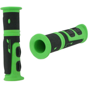The 964 Evo Grips Green / Black by Pro Grip are shown—one upright, one on its side—revealing textured surfaces and open ends. Built for 7/8 handlebars, these durable rubber grips offer comfort and control for your ride.