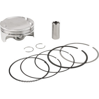 Silver metal piston, cylindrical pin, and multiple black piston rings arranged on white background.