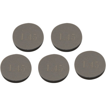 Five Prox Valve Shims (9.48 mm x 1.45 mm), precision machined for accuracy and durability, are arranged in a loose cluster on a white background. Each metal disc is engraved “1.45”. Sold as a 5 pack.
