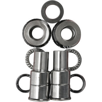 Several metal washers and cylindrical parts, arranged to resemble a robot's face, showcase components from the Pivot Works Swingarm Bearing Kit, built to OEM specifications for suspension control linkage assemblies.