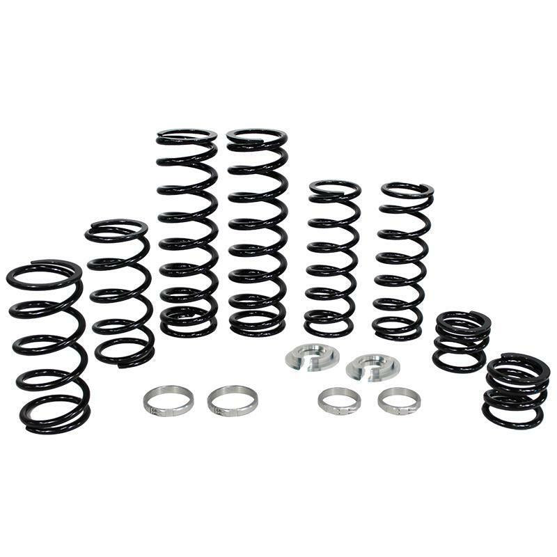 The Polaris Dual Rate Spring Kit by ZBroz features black metal coil springs of different heights, plus round silver spacers and rings—engineered to boost ride height and improve ride smoothness—all displayed against a white background.