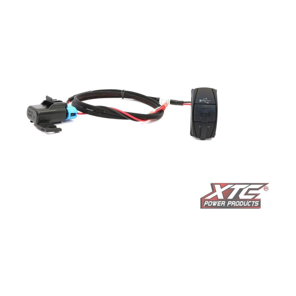 The Plug N Play Dual USB Power by XTC Power is a black wiring harness with a connector on one end and a small black switch on the other, shown beside the XTC Power Products logo on a white background.