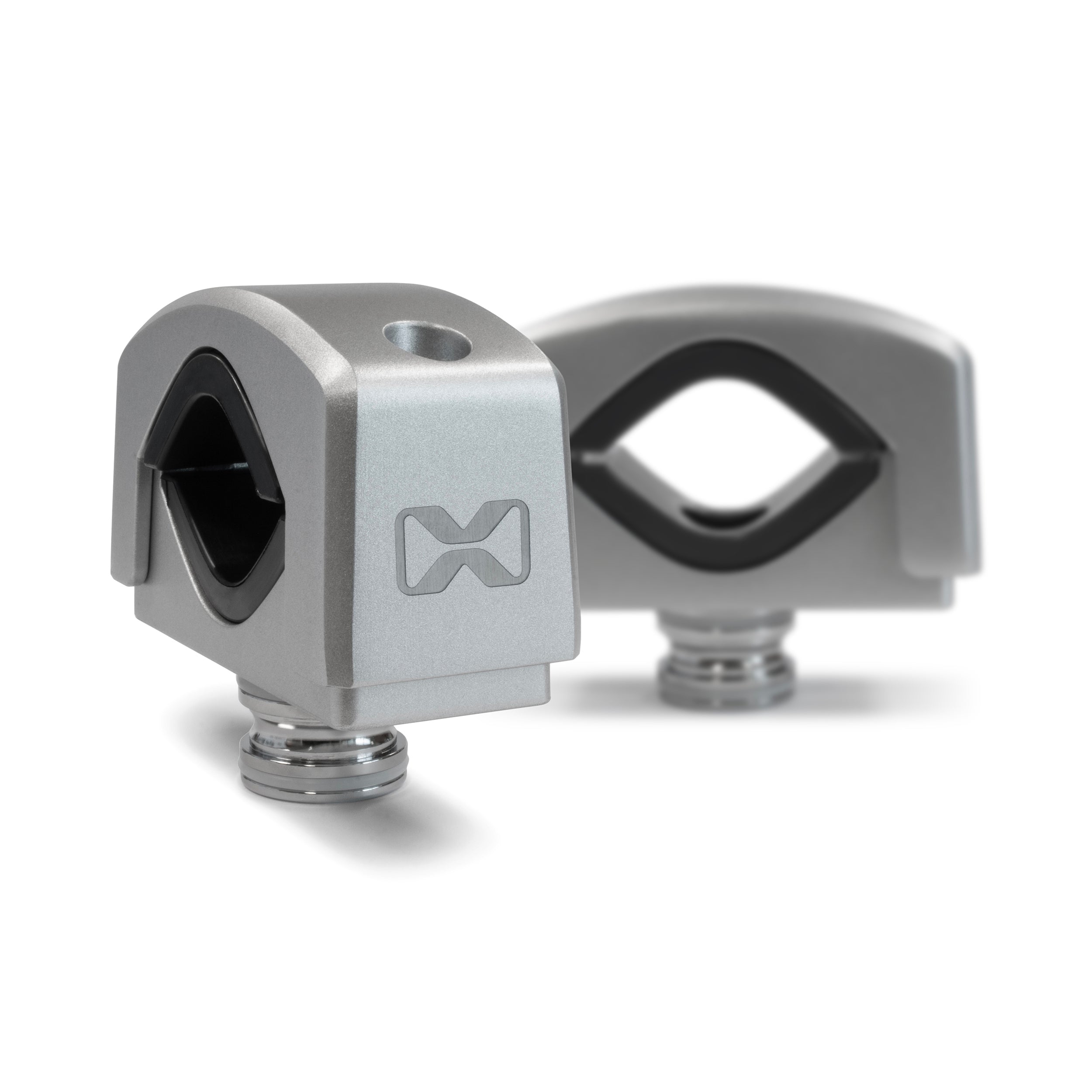Two silver, square Tower Speaker Mounts by EcoXGear with rounded edges and a hole on top, each featuring a stylized logo on the side, are displayed on a white background—one in focus, the other slightly blurred behind.