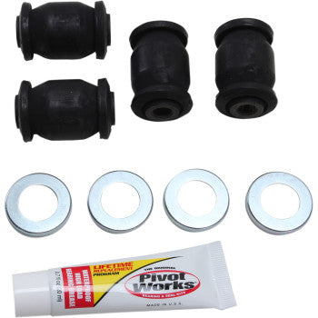 Four black cylindrical rubber bushings, four silver metal washers, and a white tube of Pivot Works grease with red and.