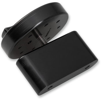 The Fuel Cap Pak Mount Black by Joker Machine is a black, rectangular billet aluminum bracket with a round, threaded knob and multiple screw holes—ideal for securely mounting accessories like a RotopaX gasoline pack.