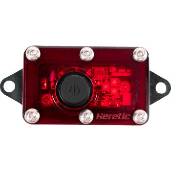 The Dome Light LED Red by Heretic is a rectangular electronic device with a red transparent cover, large black central power button, four corner LEDs, "Heretic" branding at the bottom right, and a waterproof design ideal for UTV lighting.