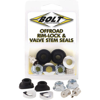 The Rim Lock Valve Stem Seal Kit Black Silver by Bolt includes black rubber valve stem grommets, metal washers, and hex nuts, with parts displayed both inside the package and laid out, perfect for off-road wheels.