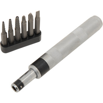 The Impact Driver 1/4" by Performance Tool is displayed in silver with a textured grip, alongside a black holder containing six interchangeable bits, including extractor options in various shapes and sizes.