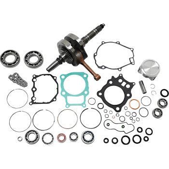 Honda engine rebuild kit with crankshaft, piston, bearings, gaskets, seals, and metal rings arranged on white background.