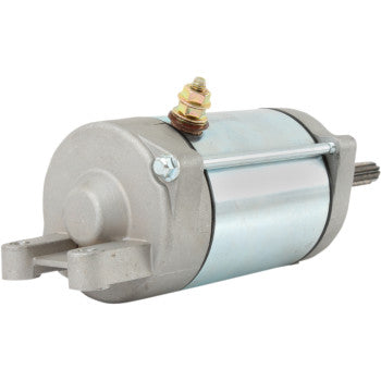 The Starter Motor by Parts Unlimited is a metal electric motor with a cylindrical body, mounting brackets, and a single stud terminal on top. It has an insulated armature and visible gear shaft, finished in silver and gray like premium OEM starters.
