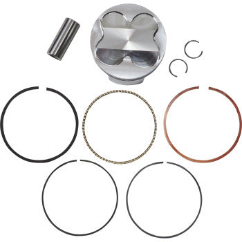 Silver metallic piston with flat top and four valve reliefs, accompanied by various black and copper piston rings, a.