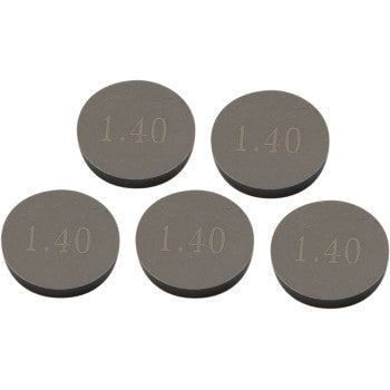 Five round, flat, metallic valve shims with "1.40" engraved on each surface.