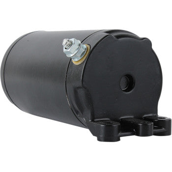 A close-up of the Starter Motor by Parts Unlimited in black, built to OEM specs, featuring a metal bolt and nuts on one end and a mounting bracket with two holes on the other.