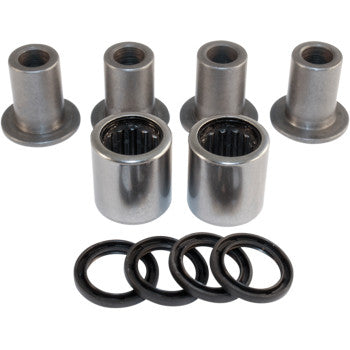 Set of four metal cylindrical bushings, two needle roller bearings, and five black rubber O-rings arranged on white.