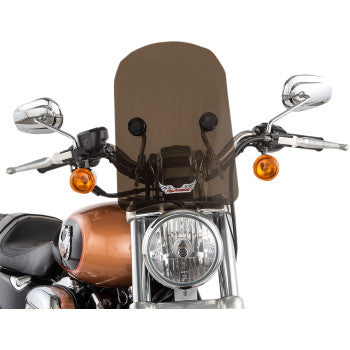 A front view of a motorcycle with a 14 tinted Tombstone Windshield by Slipstreamer, chrome mirrors, orange signal lights, a round headlight, and a brown and black color scheme.