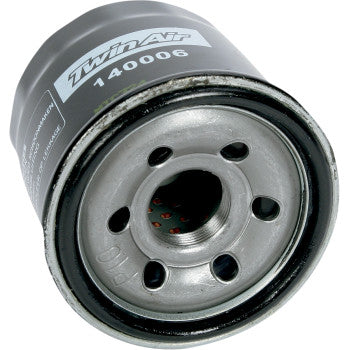 A close-up of the Suzuki - Arctic Cat Oil Filter by Twin Air, showing its metal face with holes and a central threaded opening. The label highlights its high-quality paper filter for maximum protection.