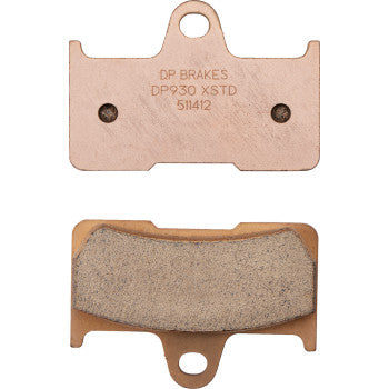 Two copper-colored Sintered Brake Pads by DP Brakes are shown. The top ATV pad has engraved text, while the bottom features a textured friction surface. Both sintered metal pads include a central mounting hole at the top.