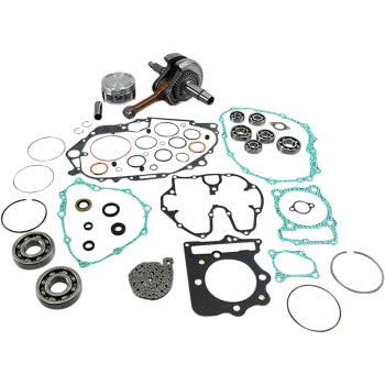 Complete Honda TRX engine rebuild kit with gaskets, bearings, piston, crankshaft, and seals in metal and silicone materials.