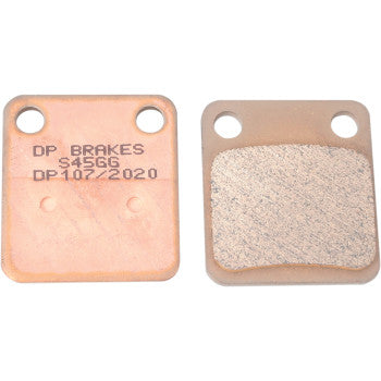 Copper-colored rectangular brake pads with rounded edges, one side plain metal, the other with textured friction material.