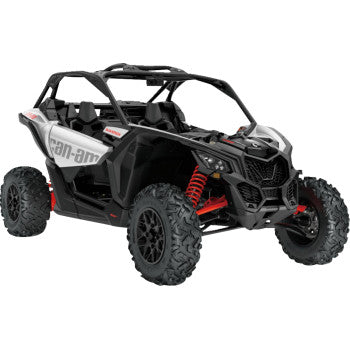 A 1:18 scale Can-Am Maverick X3 replica by New Ray Toys in Black Hyper Silver Red, featuring large rugged tires, red suspension springs, open two-seat design, and Can-Am logos on the body.