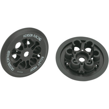 Two black circular CNC-machined aluminum Pressure Plates by Hinson Racing, each with multiple cut-out holes and HINSON RACING, BILLET PROOF, and CRF450R text etched in white, shown from different angles.