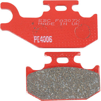 Red sport carbon brake pads with textured friction surface, metal backing plate, and white printed text.
