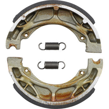 Two metallic Brake Shoes by DP Brakes, each semi-circular and worn with rust, plus two small coil springs between them, showcase the durable quality of sintered metal brake pads—all set against a white background.