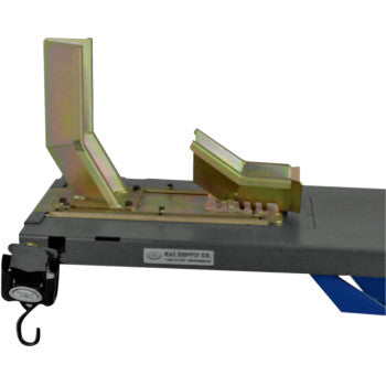 The Wheel Clamp MC10 by K&L Supply is a metal motorcycle wheel chock on a flat platform, securing the front wheel for stability during transport or maintenance—a practical addition to your K&L Lift accessories.