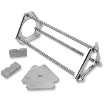 The Shock Spring Compressor by La Choppers features a metal frame with rods, triangular end plates, and three separate metal pieces—ideal for servicing stud mount shocks in the shop or garage—all displayed on a white background.